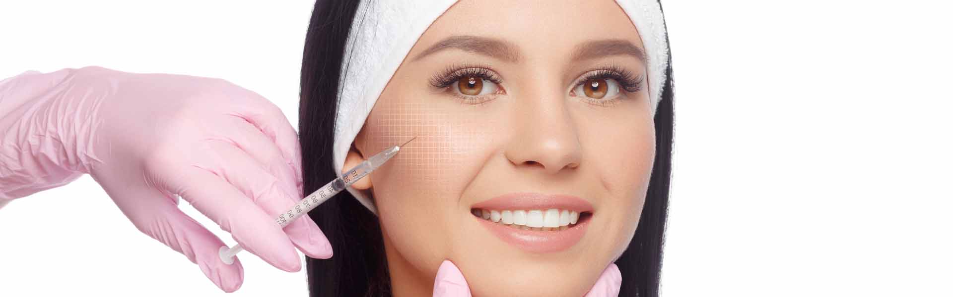 A woman receiving a facial treatment with a needle, showcasing a professional aesthetic procedure in a serene environment.