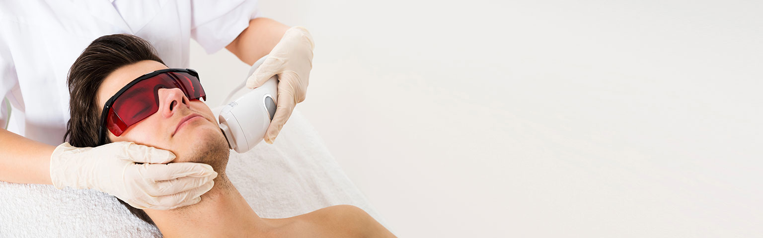 A man undergoing laser treatment on his face, focused on skin rejuvenation and improvement.